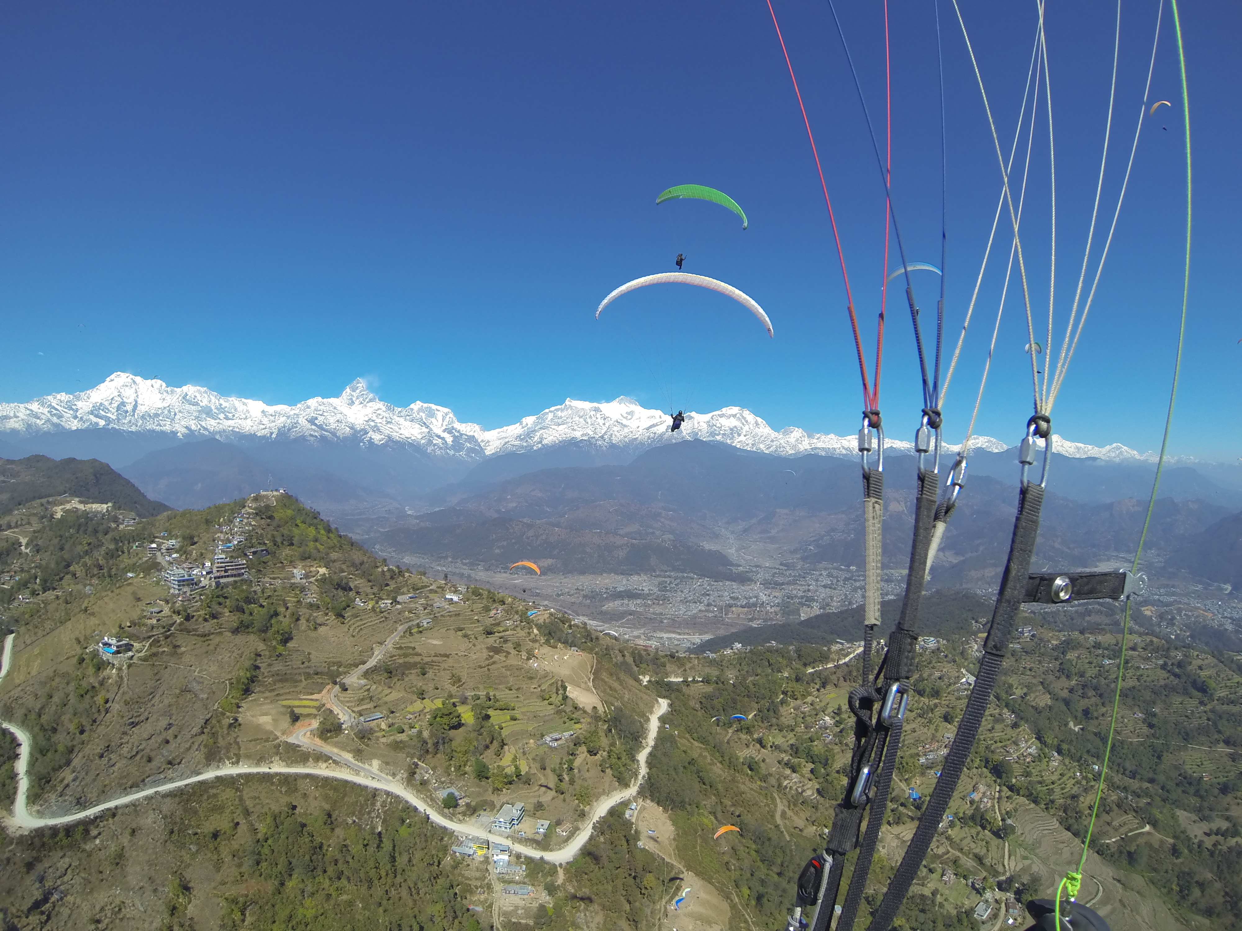 Paraglider flying in the Himalayas near Pokhara, Nepal